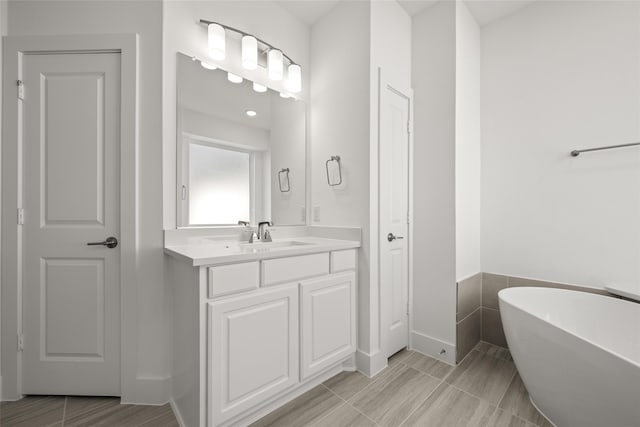 bathroom featuring a tub to relax in and vanity