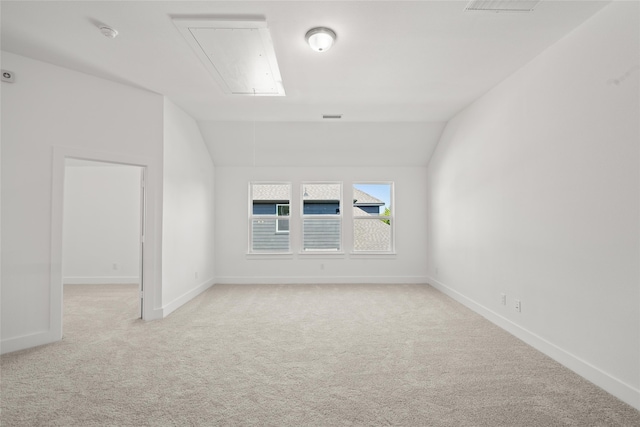 empty room with lofted ceiling and light colored carpet