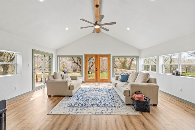 living room with light hardwood / wood-style floors, french doors, plenty of natural light, and ceiling fan