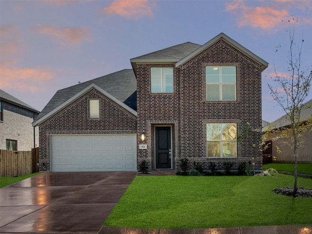 view of front of property with a yard and a garage