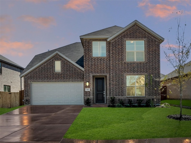 view of front of home with a garage and a lawn