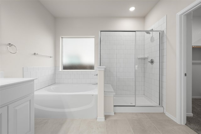 bathroom featuring independent shower and bath, tile patterned flooring, and vanity