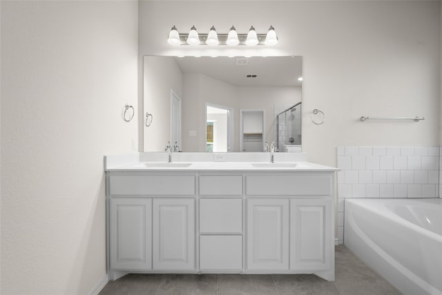 bathroom with tile patterned floors, vanity, and independent shower and bath