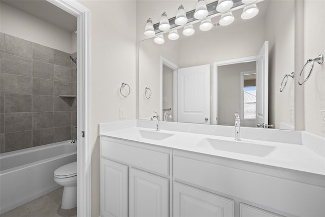 full bathroom featuring tiled shower / bath combo, tile patterned flooring, vanity, and toilet