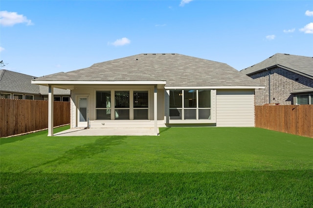 back of property with a patio area and a lawn