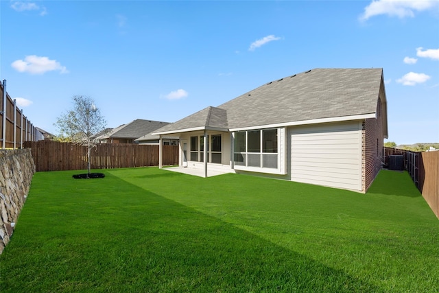 back of house featuring central air condition unit, a patio, and a yard