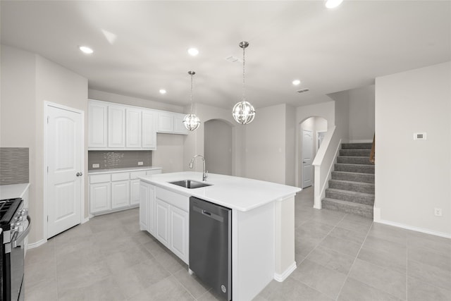 kitchen with an island with sink, white cabinets, stainless steel gas range oven, and dishwasher