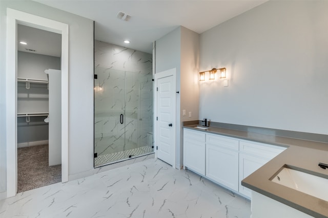 bathroom with vanity and a shower with door