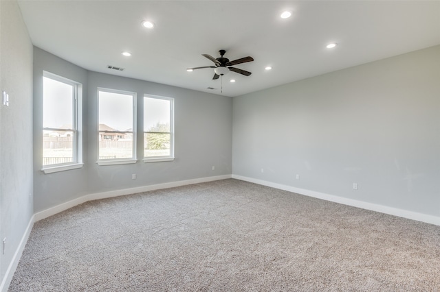 unfurnished room with ceiling fan and carpet flooring