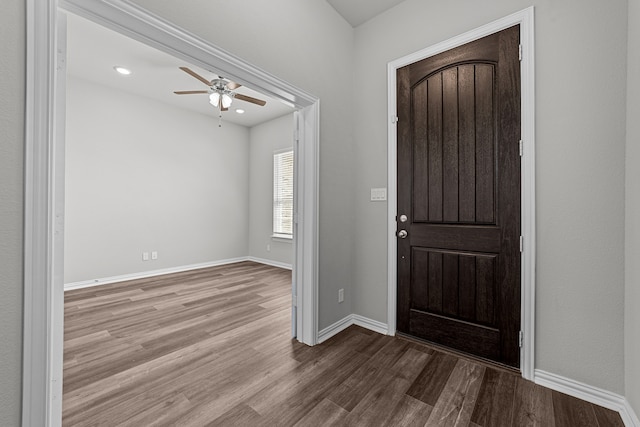 entryway with wood-type flooring and ceiling fan