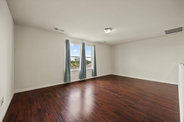 empty room with dark hardwood / wood-style floors