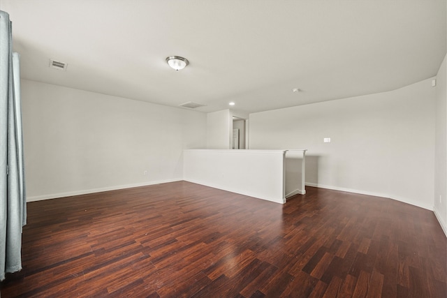 unfurnished room with dark wood-type flooring