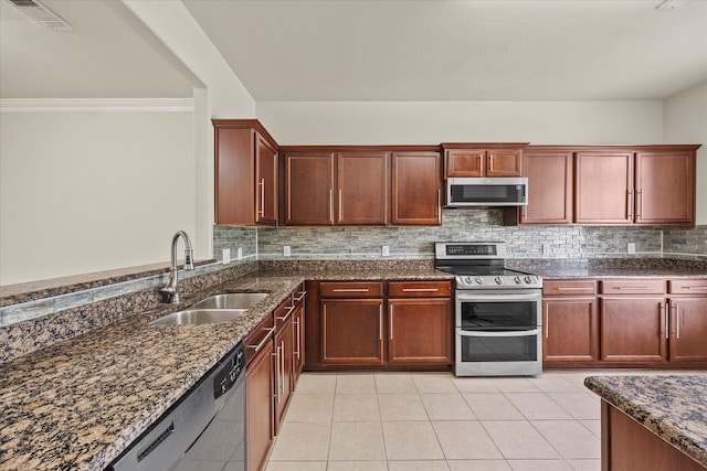 kitchen featuring dark stone counters, crown molding, sink, appliances with stainless steel finishes, and light tile patterned flooring