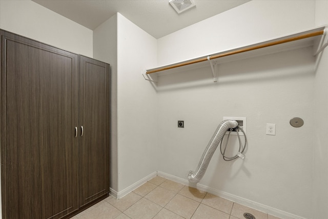 laundry room featuring washer hookup, light tile patterned floors, and hookup for an electric dryer