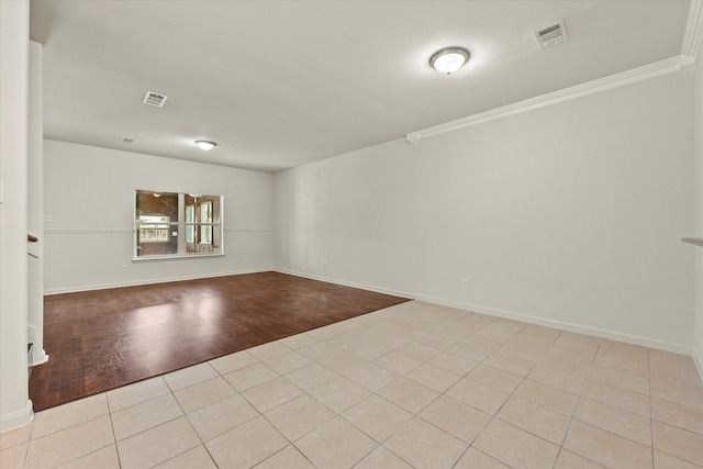 unfurnished room featuring crown molding and light hardwood / wood-style floors