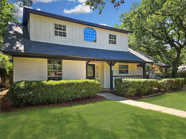 view of front of property with covered porch and a front yard