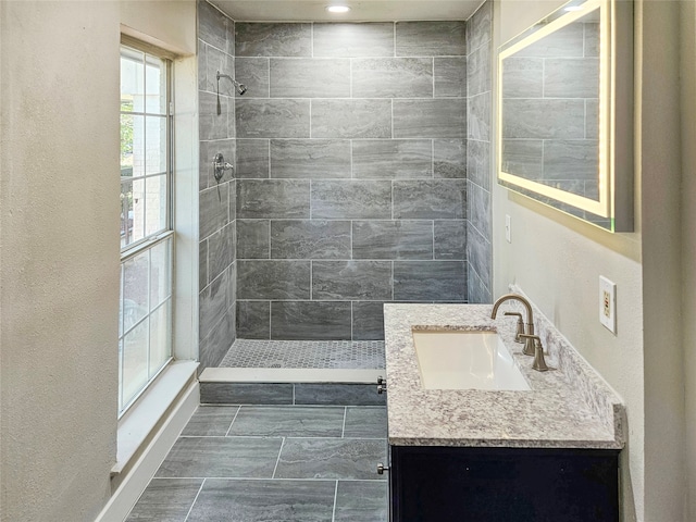 bathroom featuring vanity and a tile shower