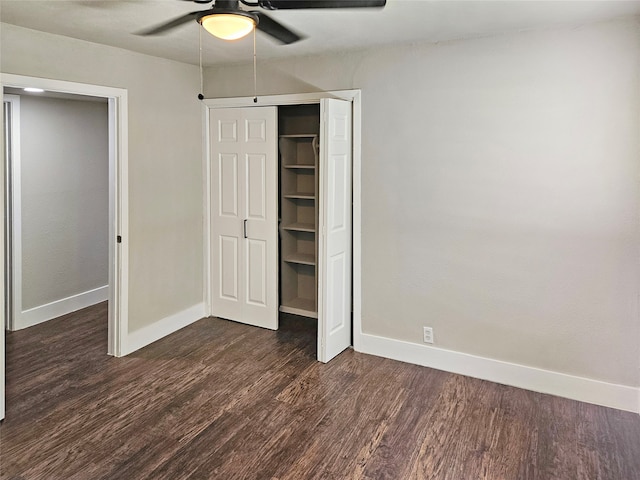 unfurnished bedroom featuring dark wood-type flooring, a closet, and ceiling fan