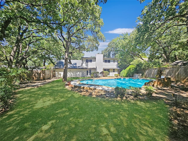 view of pool with a lawn