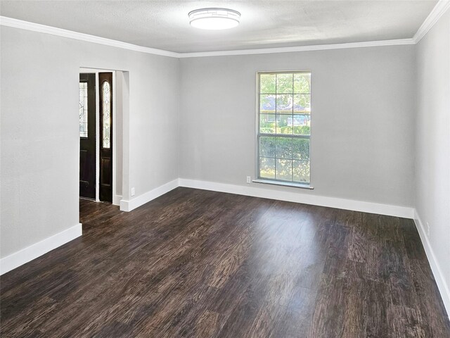 spare room with ornamental molding, dark hardwood / wood-style flooring, and a textured ceiling