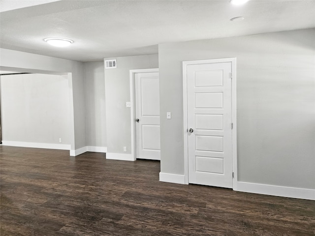 spare room with dark wood-type flooring