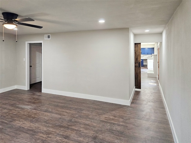 empty room featuring ceiling fan and dark hardwood / wood-style flooring