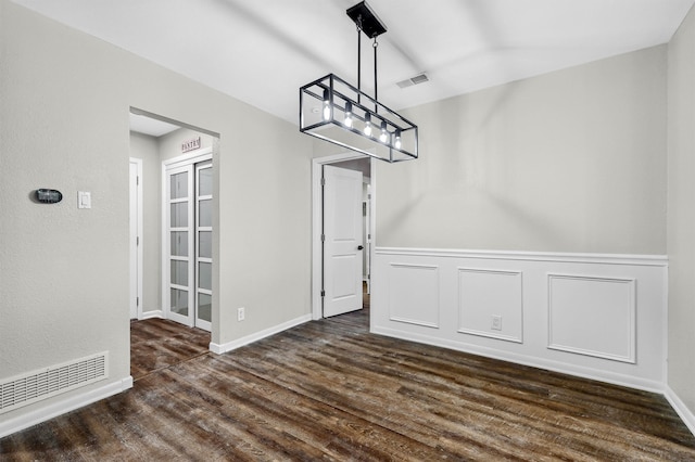 unfurnished dining area with dark hardwood / wood-style flooring