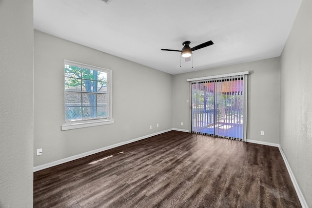 empty room with dark wood-type flooring and ceiling fan