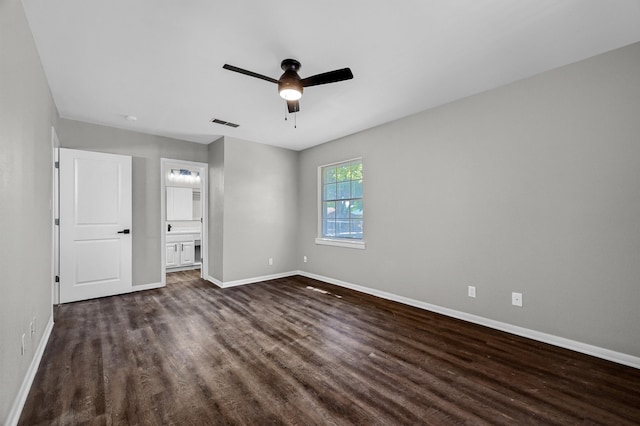 unfurnished bedroom featuring dark wood-type flooring, ceiling fan, and ensuite bathroom