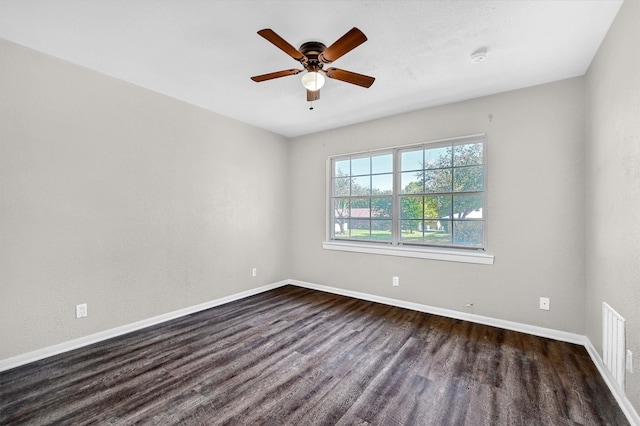 unfurnished room with dark hardwood / wood-style flooring and ceiling fan