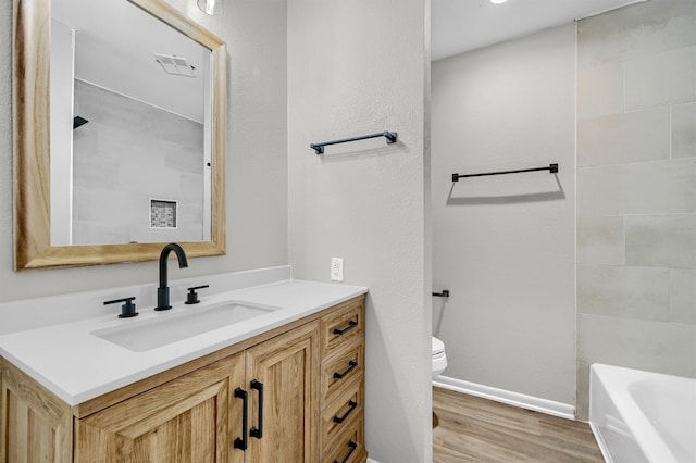 bathroom featuring hardwood / wood-style floors, toilet, and vanity