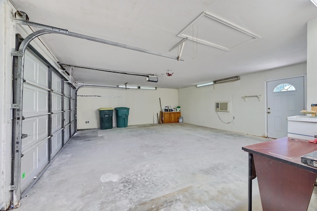 garage with a garage door opener and a wall unit AC