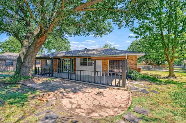 ranch-style home featuring a patio and a front lawn