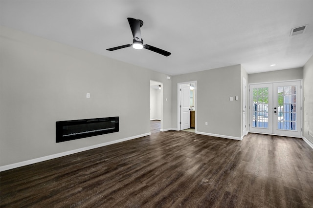 unfurnished living room with ceiling fan, dark hardwood / wood-style floors, and french doors