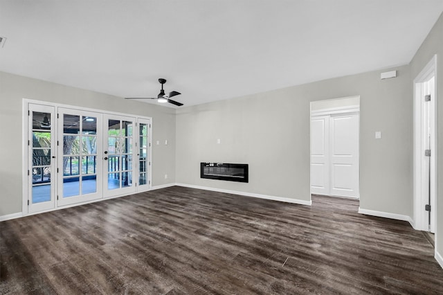 unfurnished living room featuring ceiling fan, dark hardwood / wood-style floors, and french doors