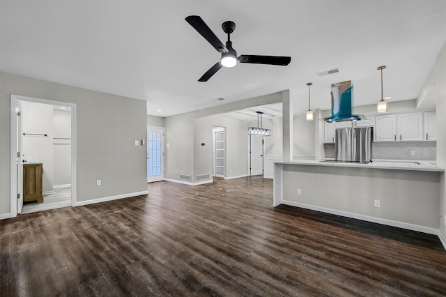 unfurnished living room with ceiling fan and dark hardwood / wood-style flooring