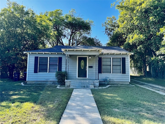 bungalow-style home featuring a front lawn