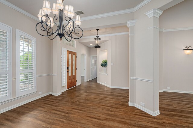 foyer with ornamental molding, a chandelier, and dark hardwood / wood-style flooring