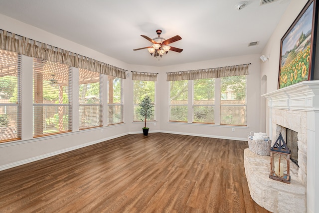 unfurnished living room featuring ceiling fan, a fireplace, and hardwood / wood-style floors