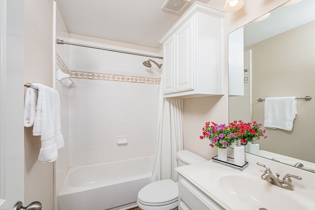 full bathroom with a textured ceiling, vanity, toilet, and shower / bath combination with curtain