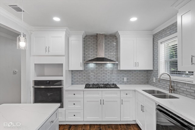 kitchen with white cabinets, sink, wall chimney exhaust hood, and black appliances