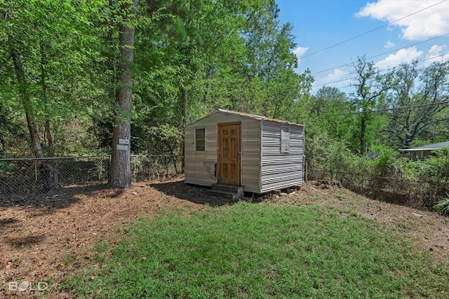 view of outbuilding with a yard