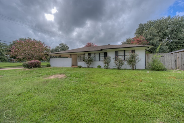 ranch-style home with a front lawn