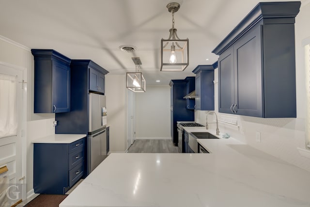 kitchen featuring hanging light fixtures, blue cabinetry, stainless steel gas range, crown molding, and sink