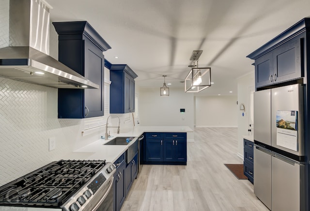 kitchen with light hardwood / wood-style floors, tasteful backsplash, stainless steel appliances, sink, and wall chimney range hood