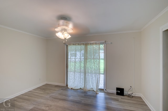 unfurnished room with ceiling fan, hardwood / wood-style flooring, and crown molding