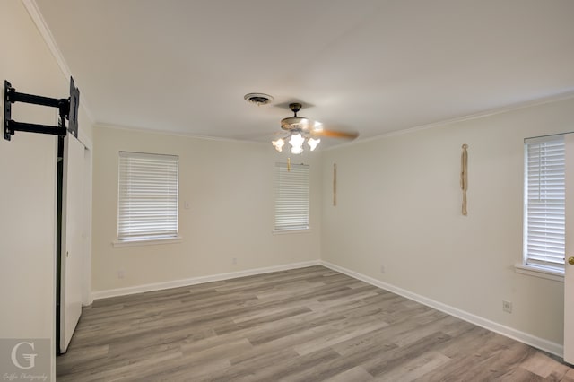 unfurnished room featuring light hardwood / wood-style flooring, ceiling fan, and crown molding