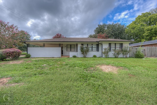 ranch-style home with a front lawn