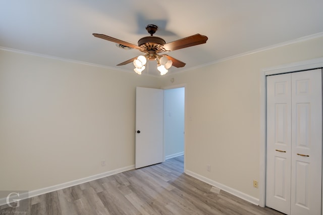 unfurnished bedroom featuring ornamental molding, ceiling fan, a closet, and light hardwood / wood-style flooring