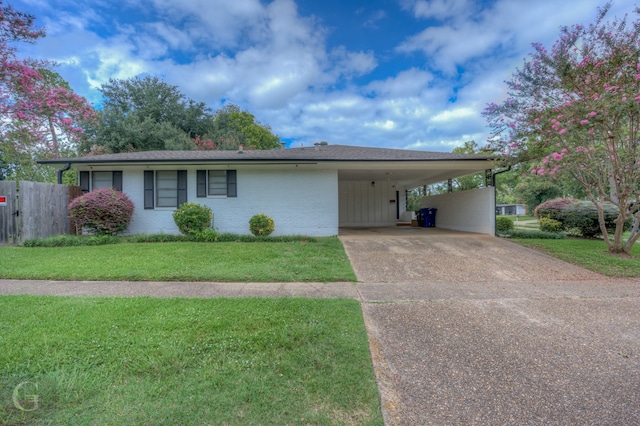 ranch-style home with a front lawn and a carport